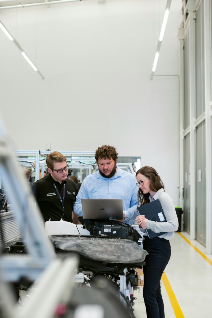 Female electronics engineer tests vehicle software with team